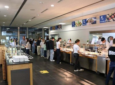 Bild aus dem Mensebetrieb am Deutsch-Luxemburgischen Schengen-Lyzeum mit Kindern die anstehen für ihr Essen 