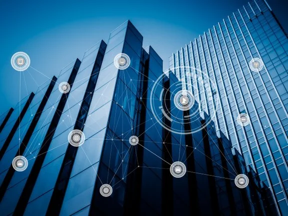 Ein Bild einem Hochhaus, auf dem Bild sind verschiedene graue runde Icons die mit einanderverbunden sind